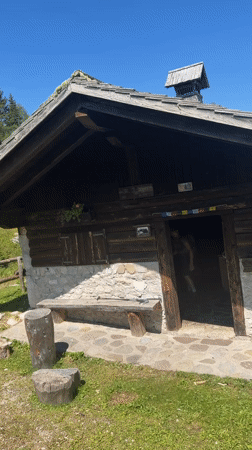 Leaving a mountain cabin in the Dolomites on a summer hike