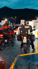 Motorcyclists cross Montenegro waters by ferry at dusk