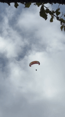 Paragliders soar over scenic Fethiye coastline under cloudy skies