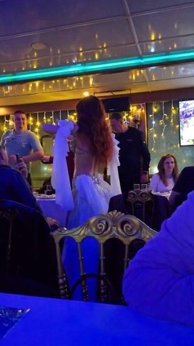 Belly dancer performs for diners on Turkey dinner cruise