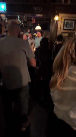 Acoustic musician performs to engaged crowd at Dublin pub