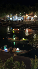 Nighttime crowds gather at Hội An waterfront entertainment district