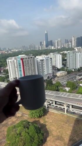 Morning Coffee Ritual Documented Against Kuala Lumpur Skyline