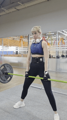 Woman performs sumo deadlift during early morning workout in Chaikovsky