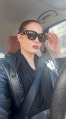 Woman in black leather jacket observed in car in Riga