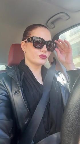 Woman in black leather jacket observed in car in Riga