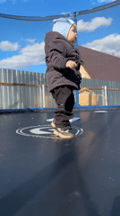 Toddler plays on trampoline in sunny Chaikovsky, Russia