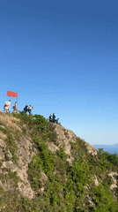 Chinese flag displayed on rocky hilltop in Vladivostok