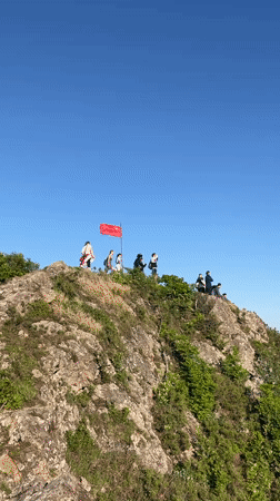 Chinese flag displayed on rocky hilltop in Vladivostok