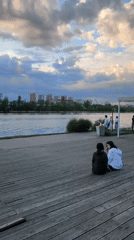 Afternoon visitors gather at Moscow waterfront park's wooden boardwalk
