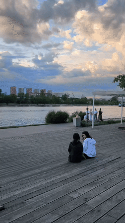 Afternoon visitors gather at Moscow waterfront park's wooden boardwalk