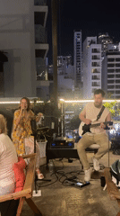 Rooftop music performance documented in nighttime Nha Trang