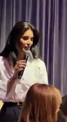 Woman speaks at indoor public event in Kyiv
