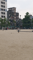 Children play soccer and cricket in Dhaka field