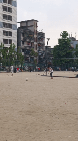 Children play soccer and cricket in Dhaka field