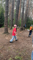 Kids run an outdoor course in a Chaikovsky forest