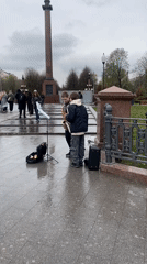 Street musicians perform saxophone in Moscow park