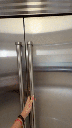 Person opens well-stocked refrigerator in Key Biscayne home