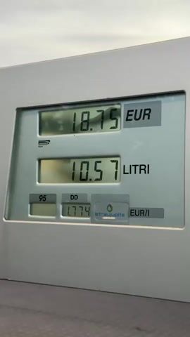 The video shows a close-up of a gas pump display. The display shows the amount of gas being pumped in liters, the total cost in Euros, and the price per liter in Euros. The numbers on the display are increasing as the gas is being pumped. The price per liter is 1.774 EUR/l. The words STRAUJUPITE are also visible on the display. The gas type "95" is shown on the lower-left corner.