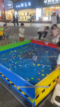 Carnival games, rides, and street food on a Qinhuangdao night strip