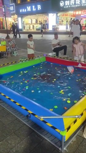 Carnival games, rides, and street food on a Qinhuangdao night strip