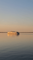 Cruise ship spotted sailing near Chaikovsky, Russia at sunset
