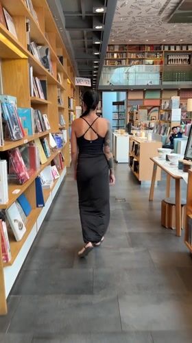 Woman with tattoos spotted browsing Bangkok bookstore early morning