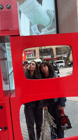 Women pose for selfie with vintage TV in Yerevan