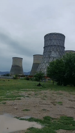 Workers inspect industrial pipelines at Taraz power facility