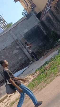 Morning scenes in Lagos show street musician, construction activity