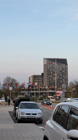 Motorcyclist refuels scooter at Sofia gas station while carrying detergent