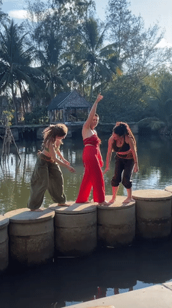 Women cross water on stepping stones in Đà Nẵng