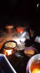 Night vendor cooks food over open fire in Keffi