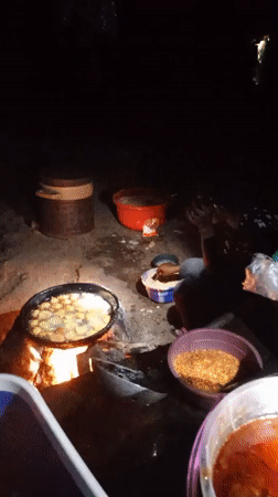 Night vendor cooks food over open fire in Keffi