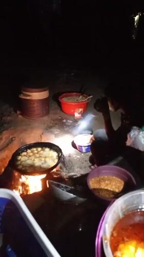 Night vendor cooks food over open fire in Keffi