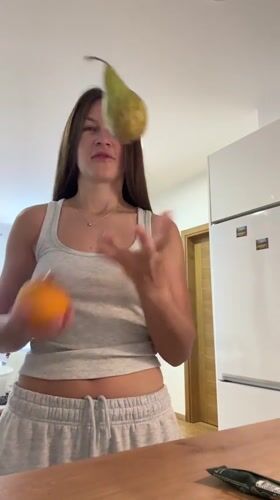 Woman juggles fruit in Montenegro kitchen Wednesday morning