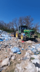 Tractor sits among trash pile in Bulgarian countryside