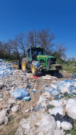Tractor sits among trash pile in Bulgarian countryside