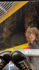 Person cleans yellow vehicle window with squeegee in Haifa