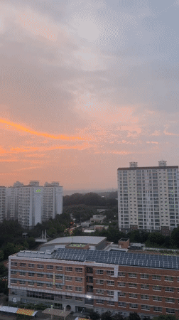 Pyeongtaek-si glows under a dramatic orange and pink sunset sky