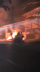 Debris fire burns on street in Lhokseumawe, Indonesia