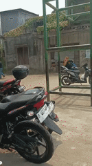 School morning activity and scooter traffic near West Jakarta gate