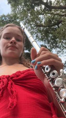 Flute player among Budva's old town squares and stone towers