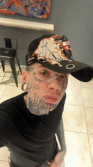 Tattooed man takes selfie at Buenos Aires art gallery