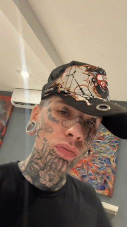Tattooed man takes selfie at Buenos Aires art gallery