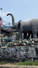 Elephant statue filmed in busy Dhaka street scene