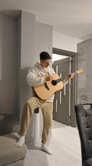 Young guitarist performs casual indoor session in Burgas apartment
