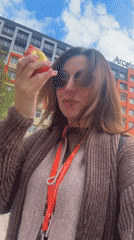 Woman eats apple outdoors in Kryvyi Rih, Ukraine