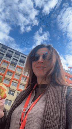 Woman eats apple outdoors in Kryvyi Rih, Ukraine