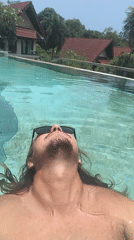 Man enjoys early morning swim in Thai residential pool